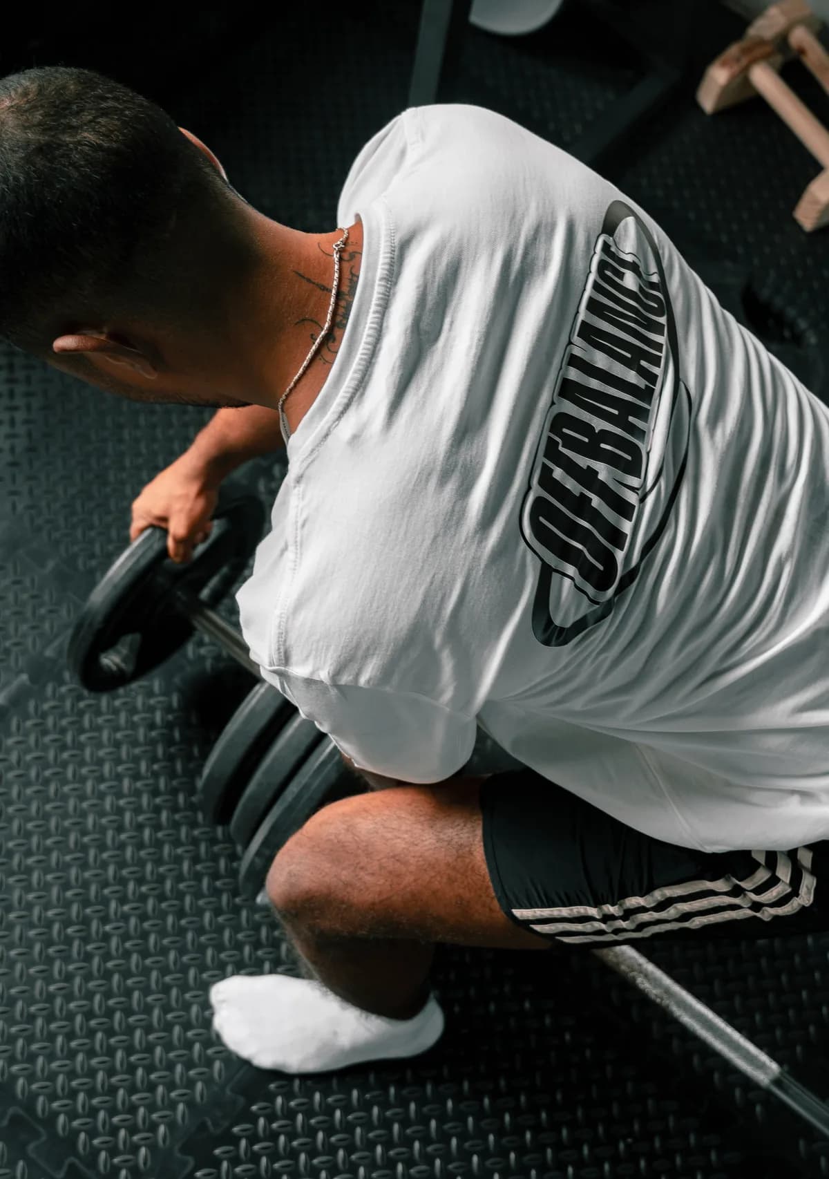 CJ setting up a barbell for a lift