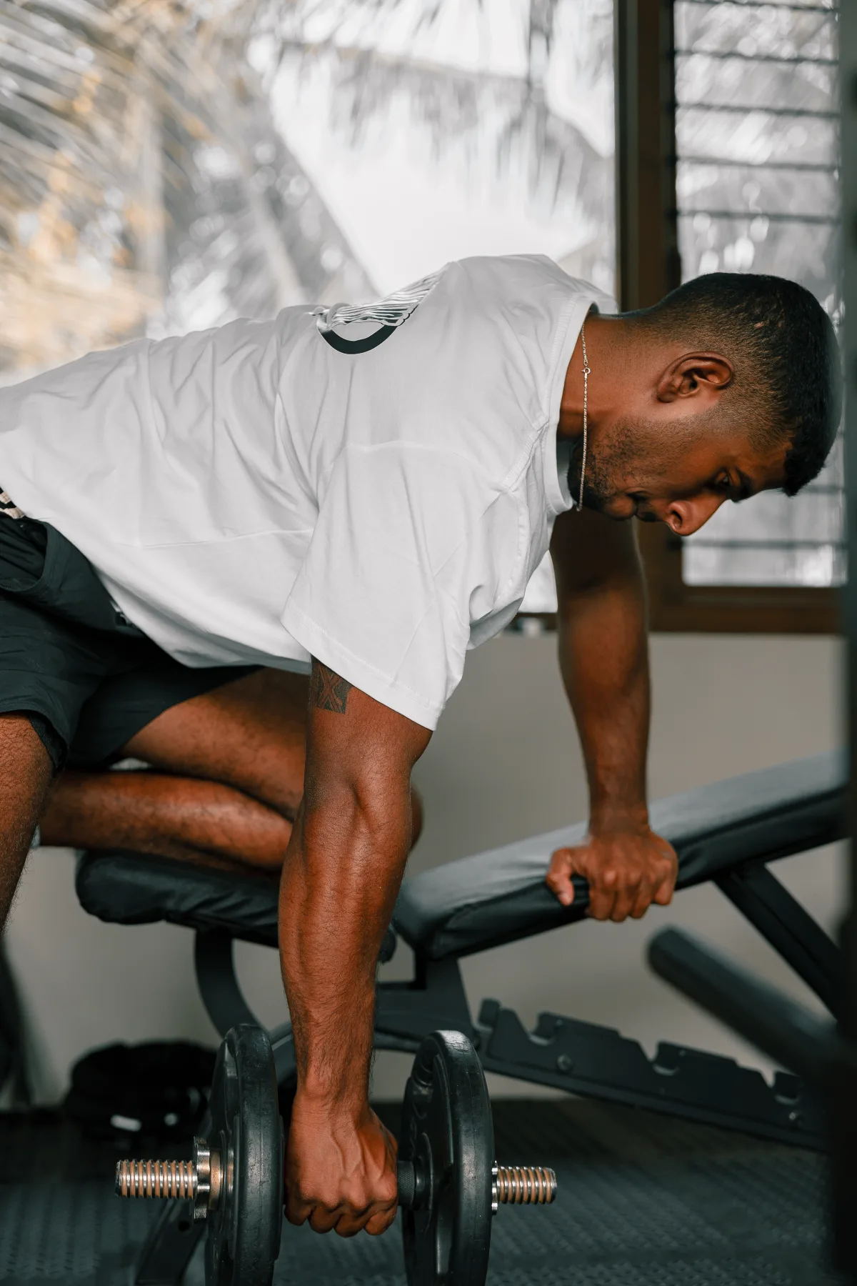 CJ performing a single-arm dumbbell row